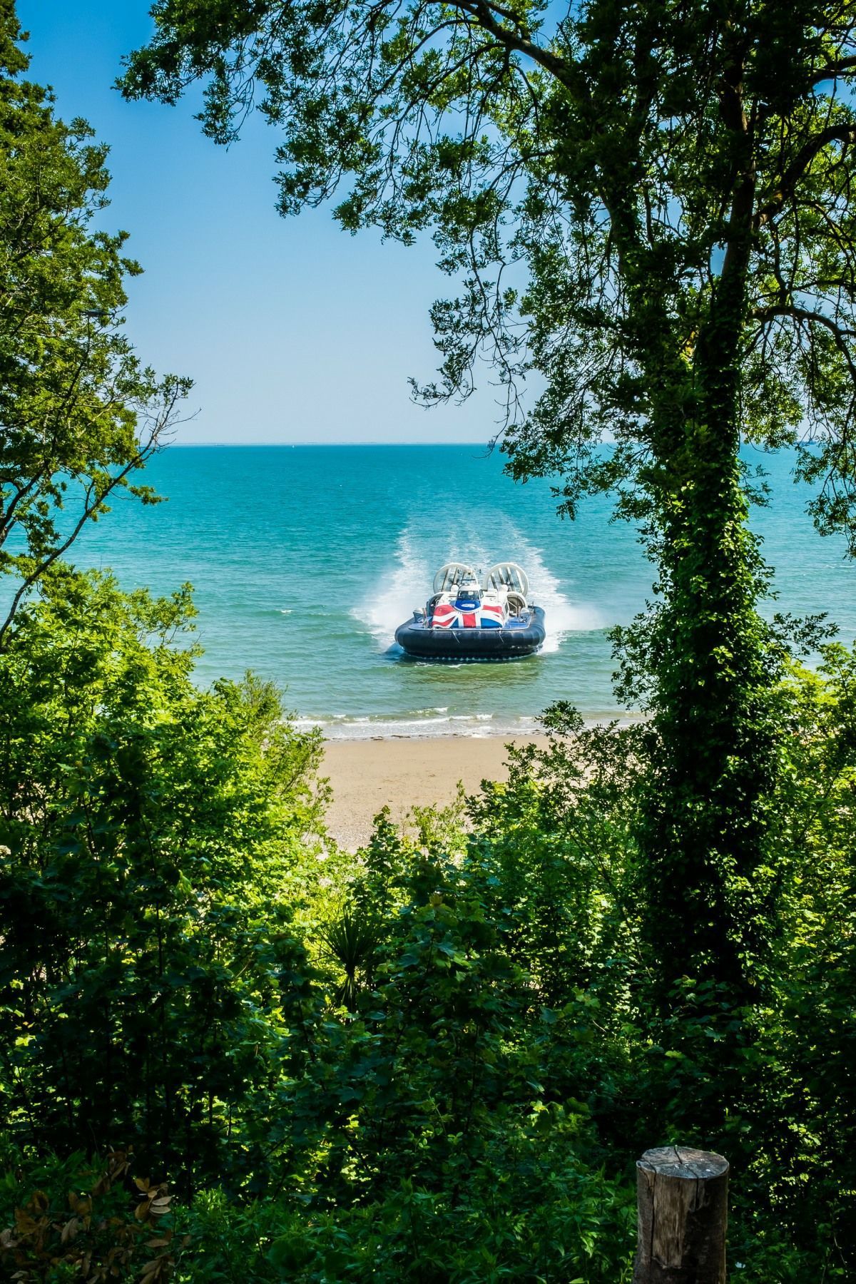 A boat is going through the water on a sunny day