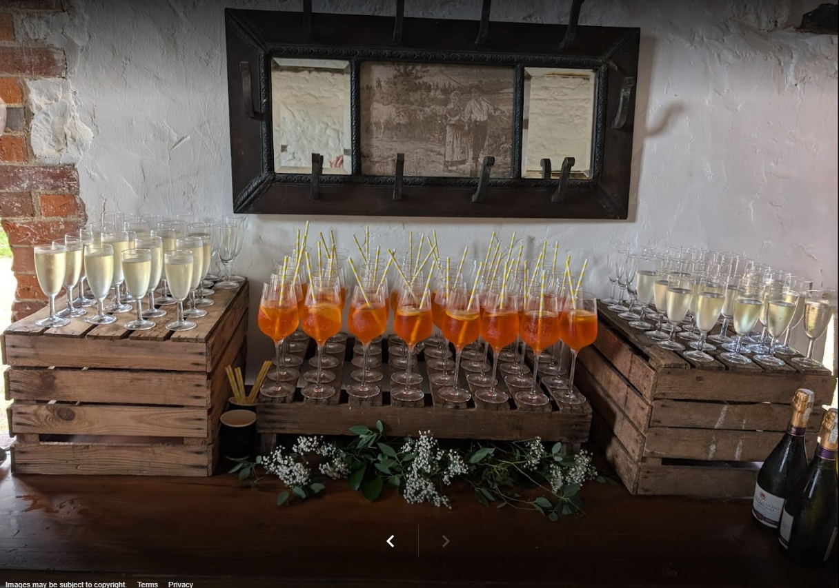 A table with lots of glasses of champagne on it.