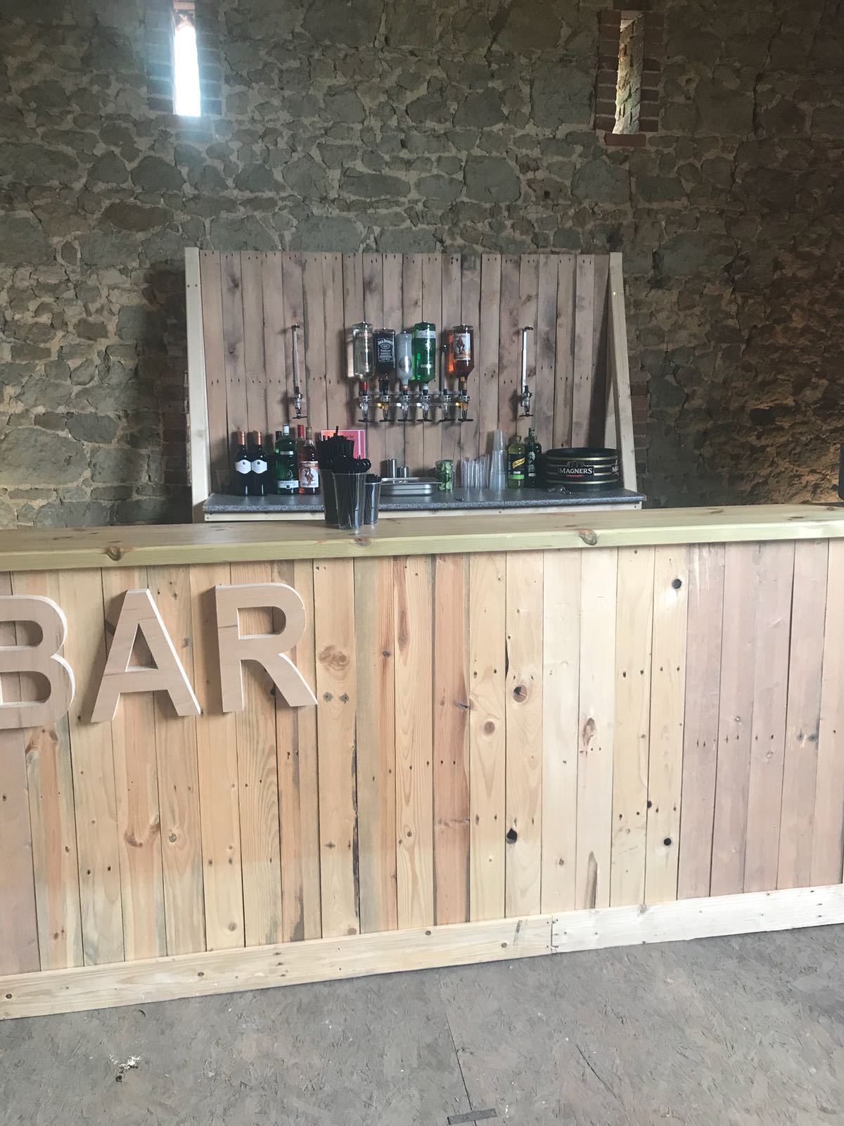 A wooden bar with the word bar written on it.