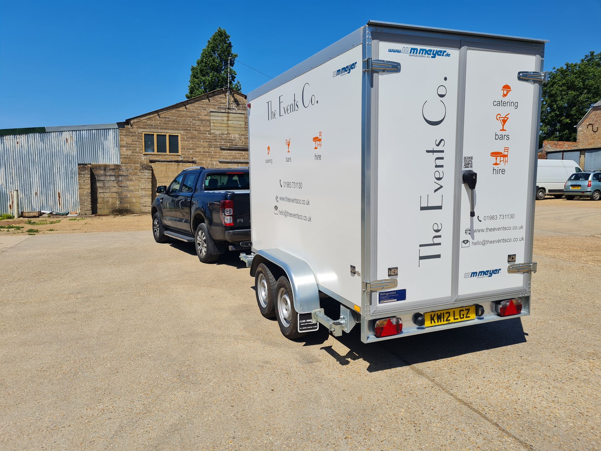 A truck is pulling a trailer that says the events co.