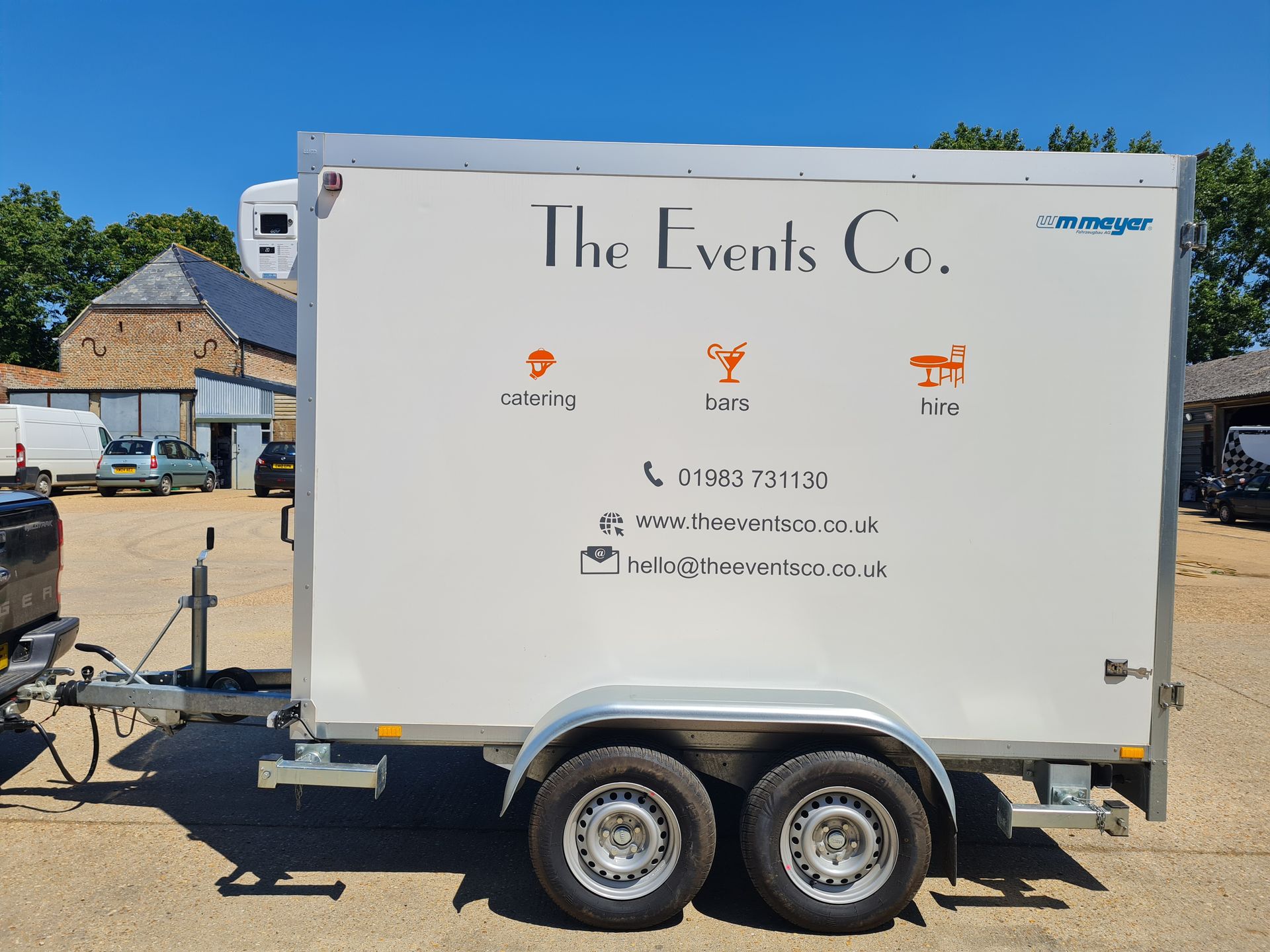 A white trailer with the events co. written on it