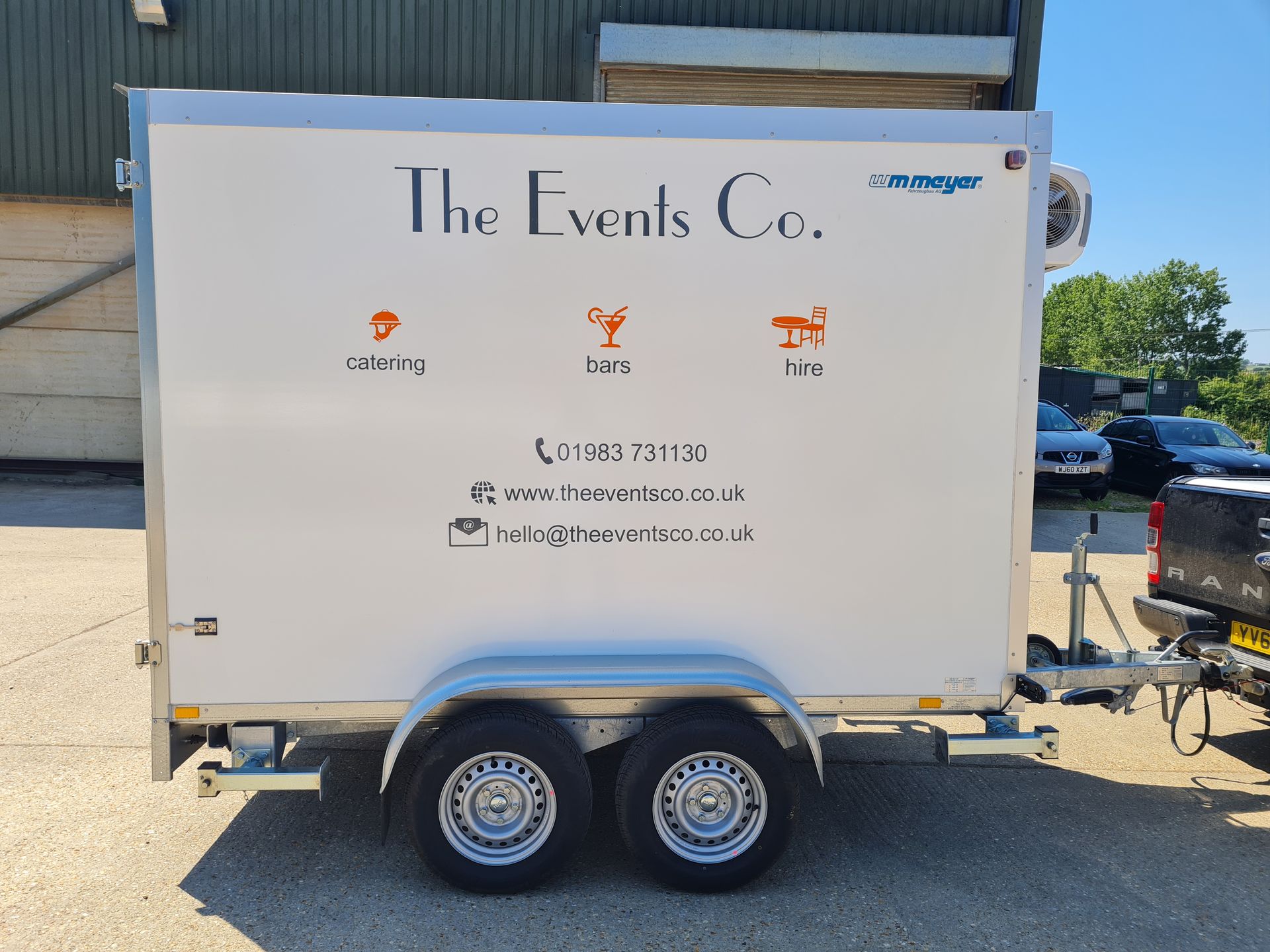 A white trailer with the events co. written on it