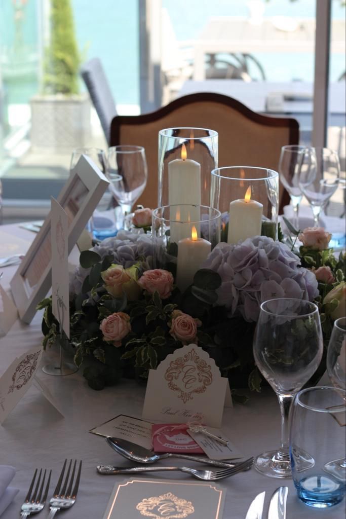 A table setting with candles and flowers on it