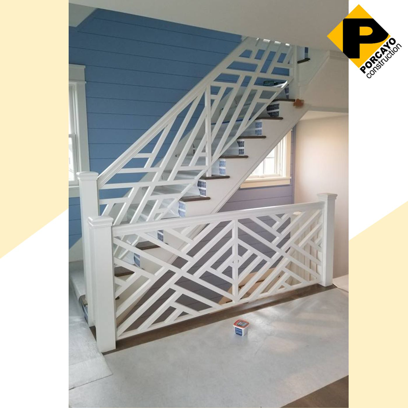 A staircase with a geometric design on the railing