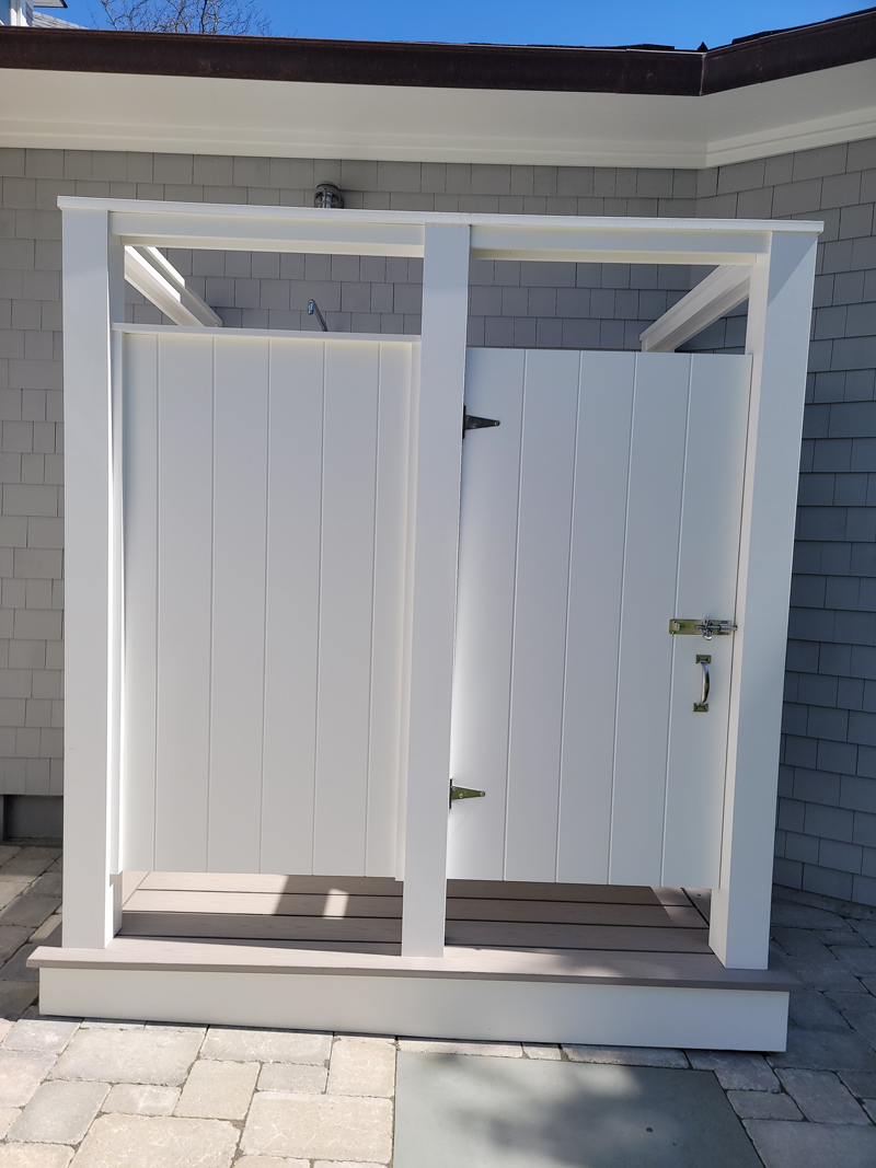 A white shed with a door that is open