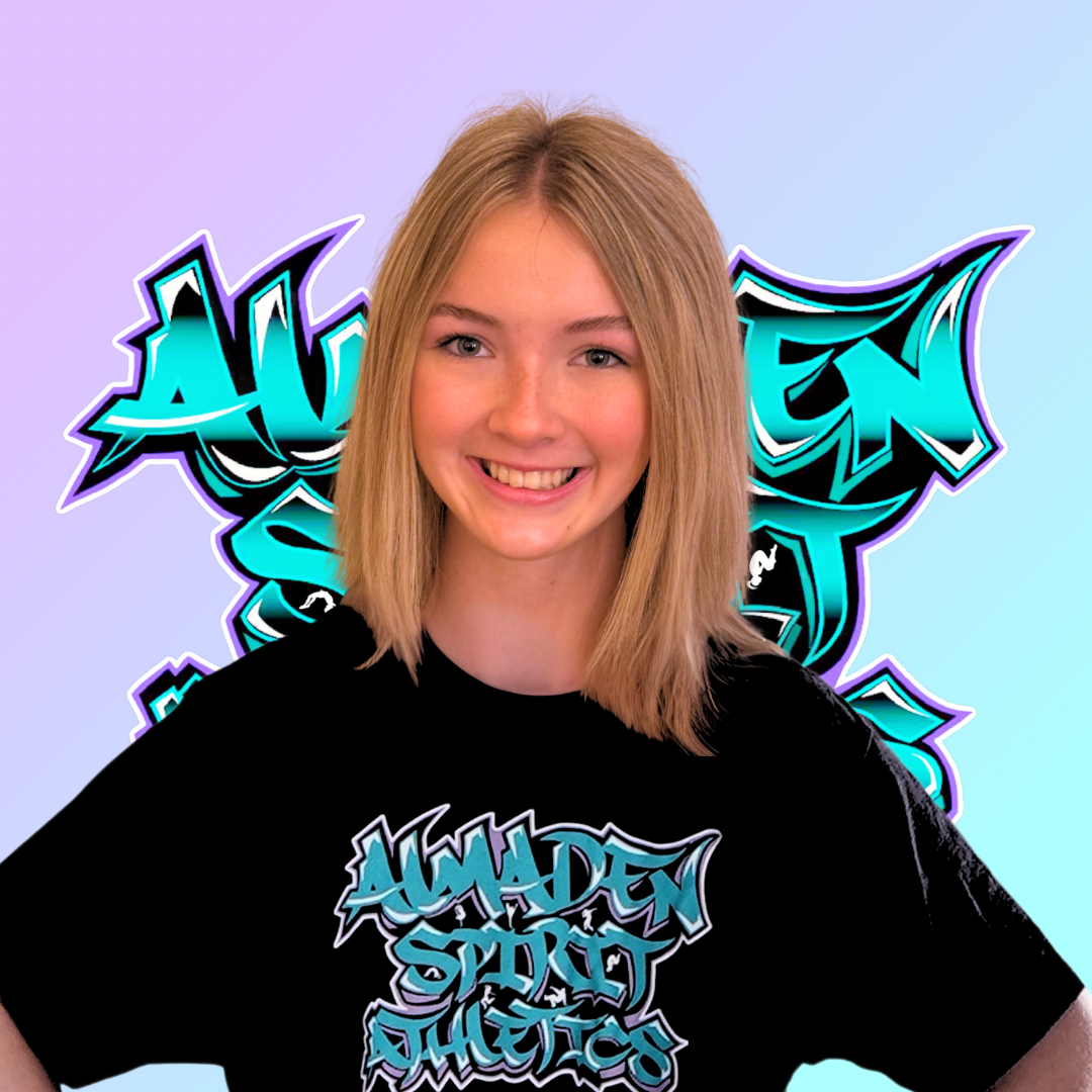 A woman is wearing a black t-shirt with graffiti on it.