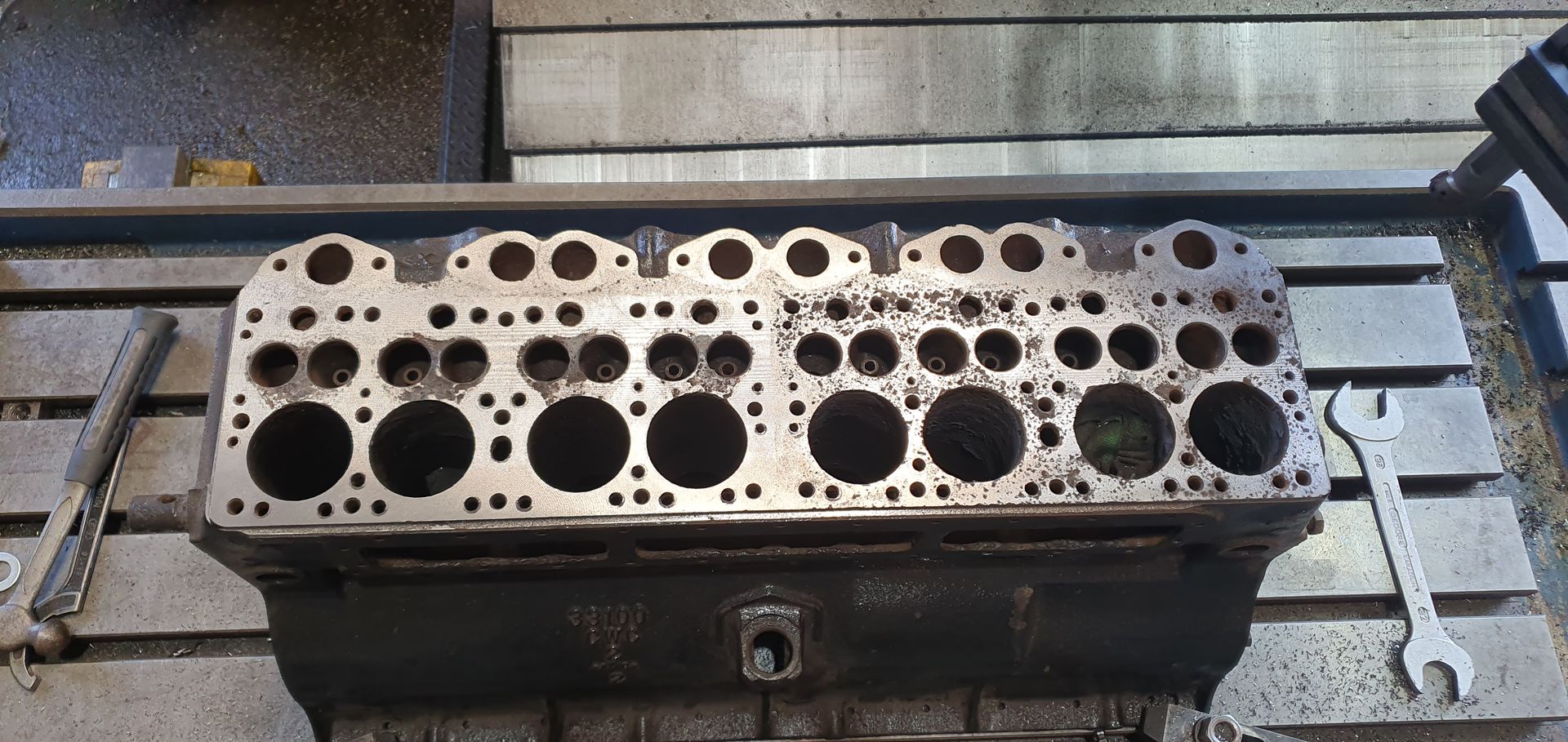 A piece of metal with holes in it is sitting on a table.