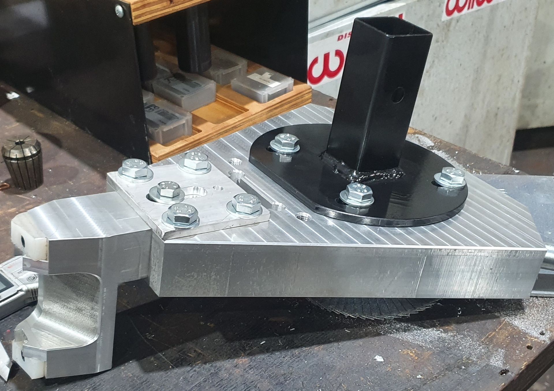 A piece of metal is sitting on a table next to a sign that says cu