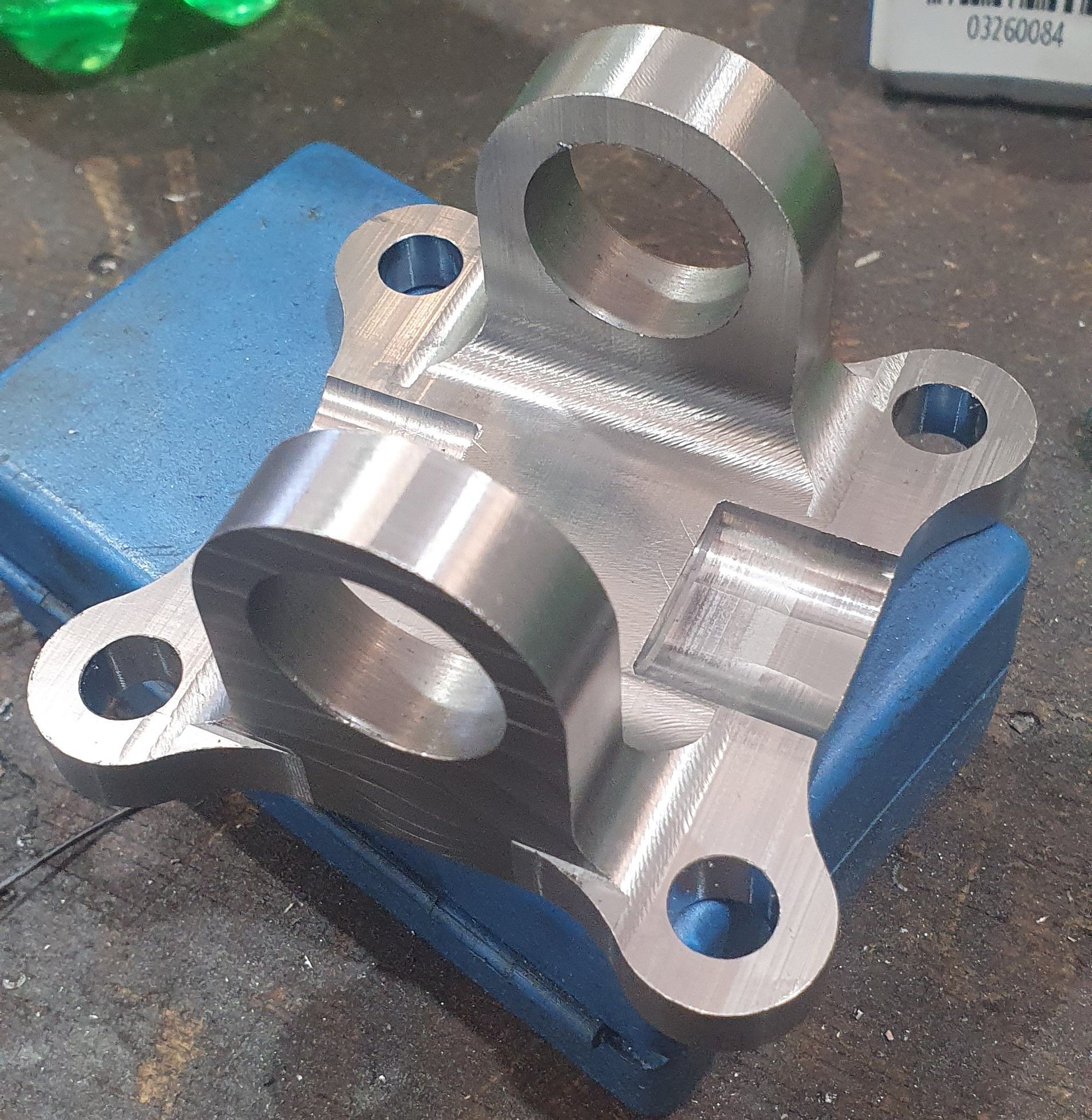 A piece of metal is sitting on top of a blue box