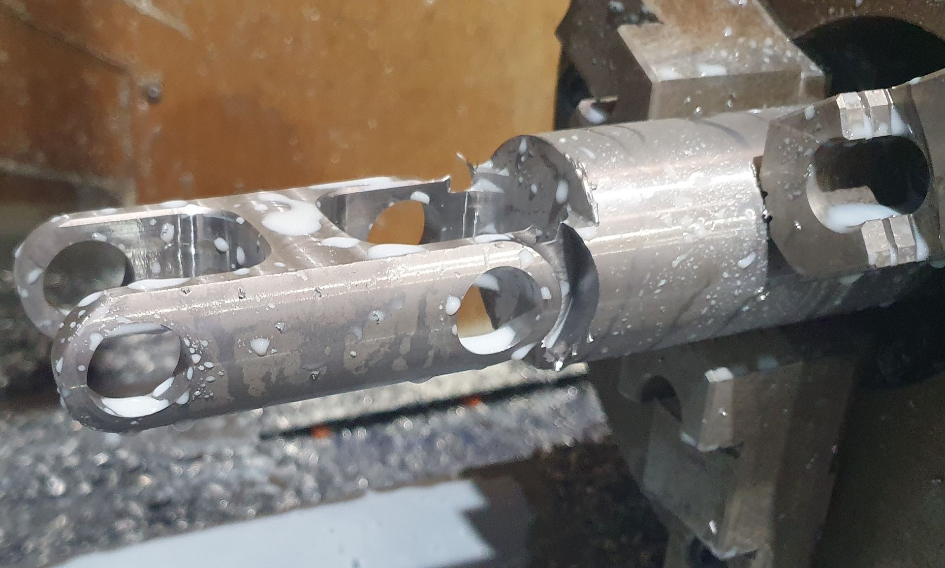 A piece of metal is being worked on by a machine.