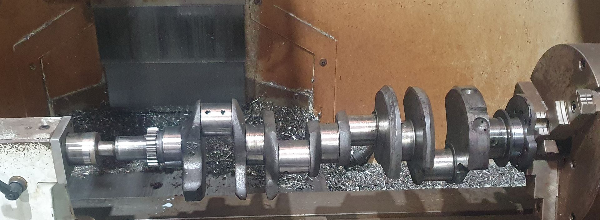 A crankshaft is being machined on a lathe.