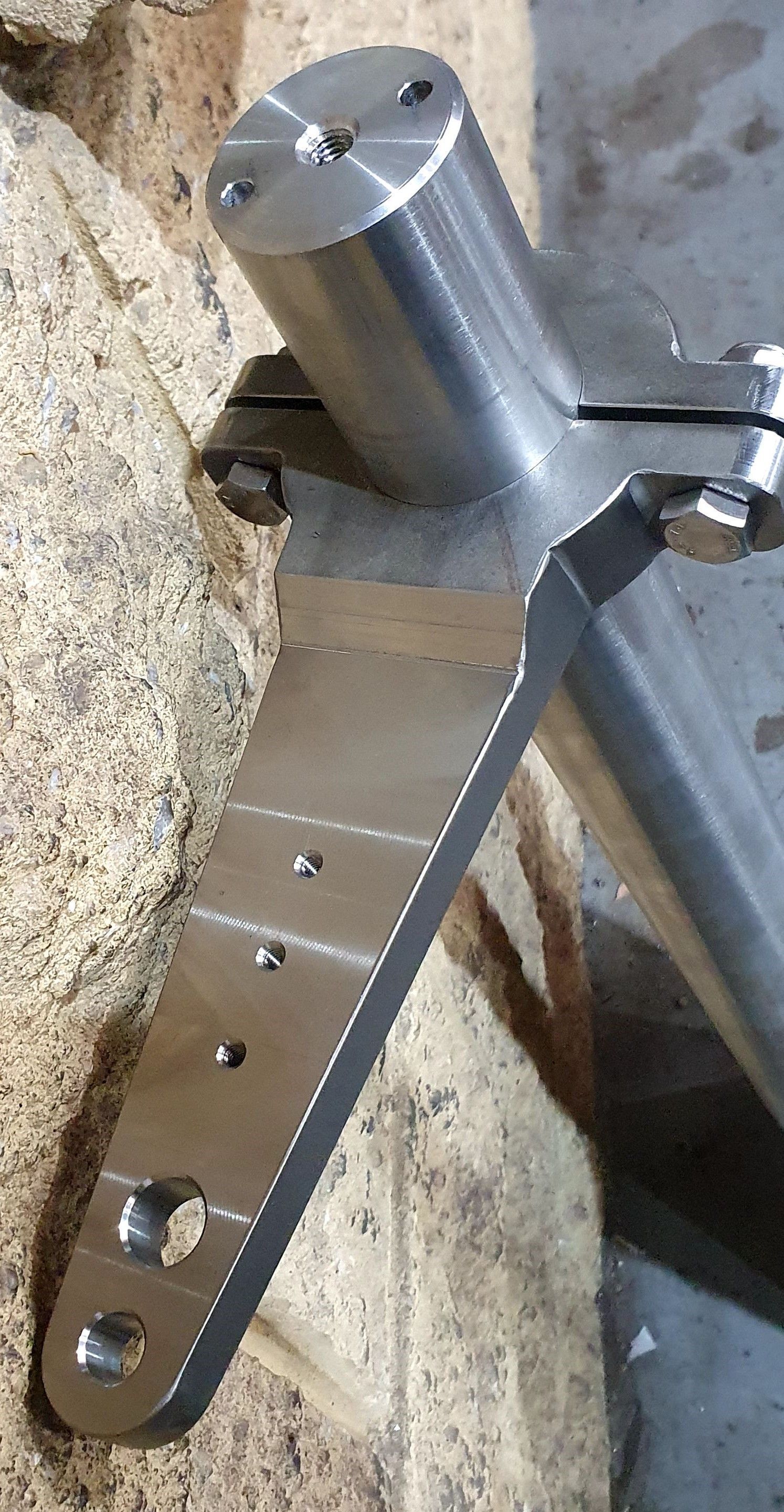 A piece of metal is sitting on top of a piece of wood.