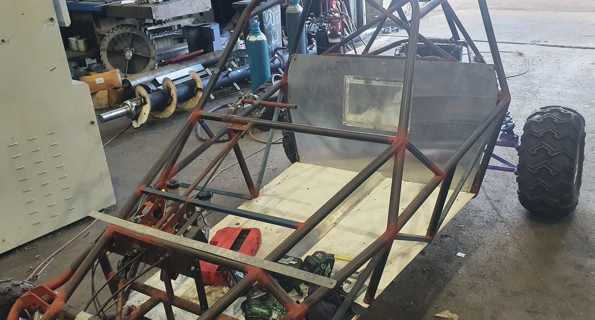 A buggy is being built in a garage.