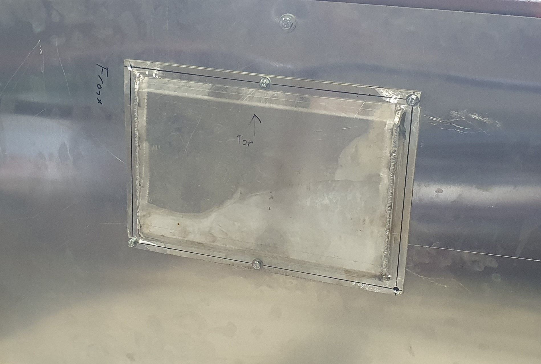 A clear plastic container is sitting on top of a metal surface.