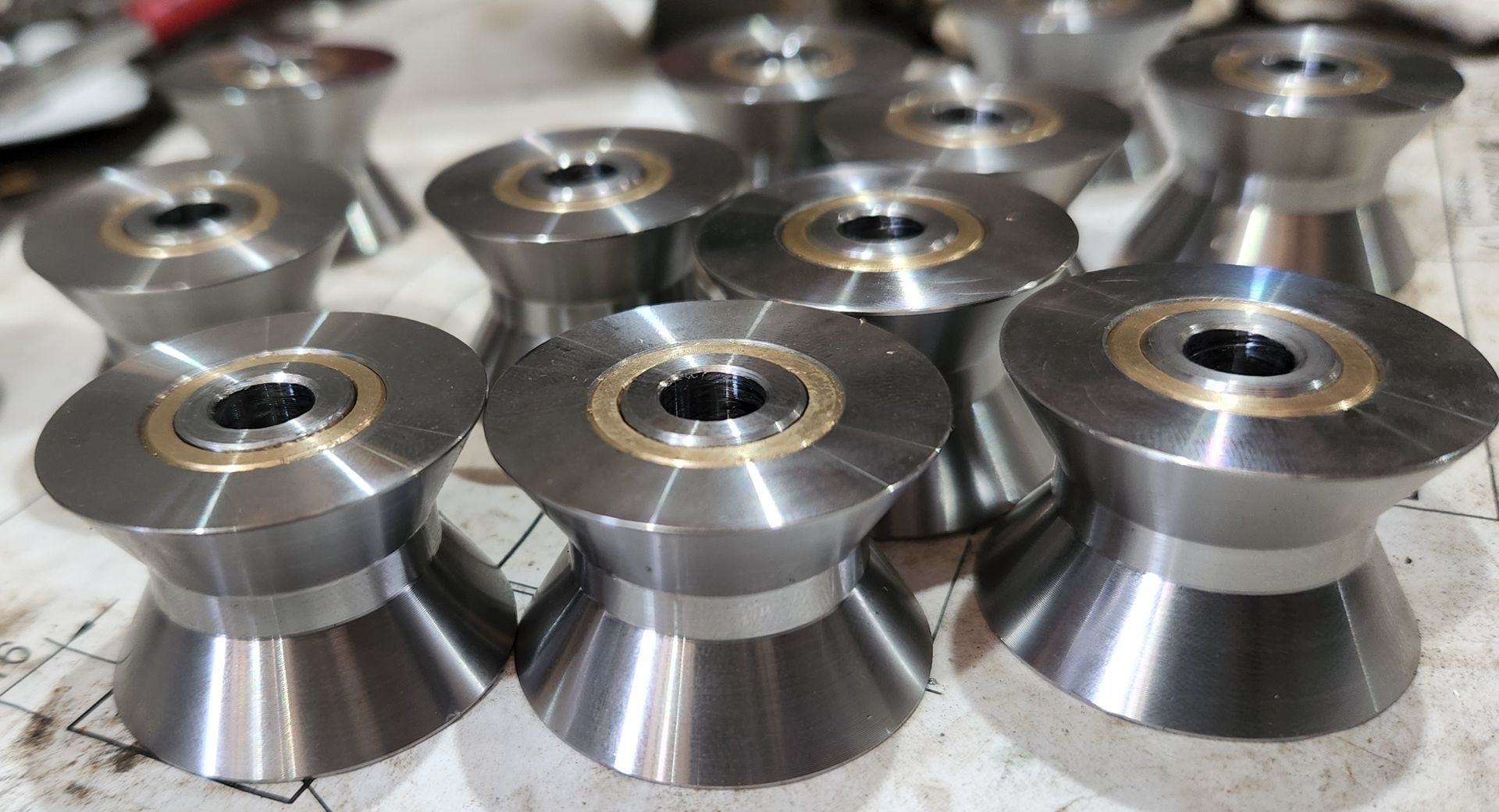 A bunch of metal cylinders are sitting on top of each other on a table.