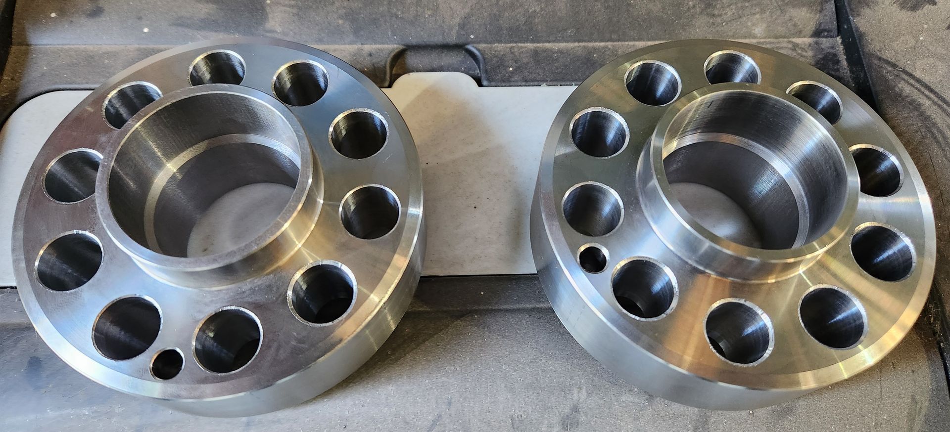 A pair of wheel spacers are sitting on a table