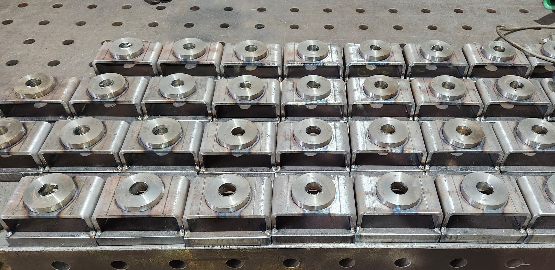 A bunch of metal pieces are stacked on top of each other on a table.