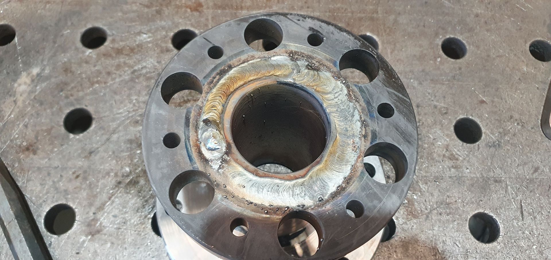 A close up of a metal object with holes in it on a table.