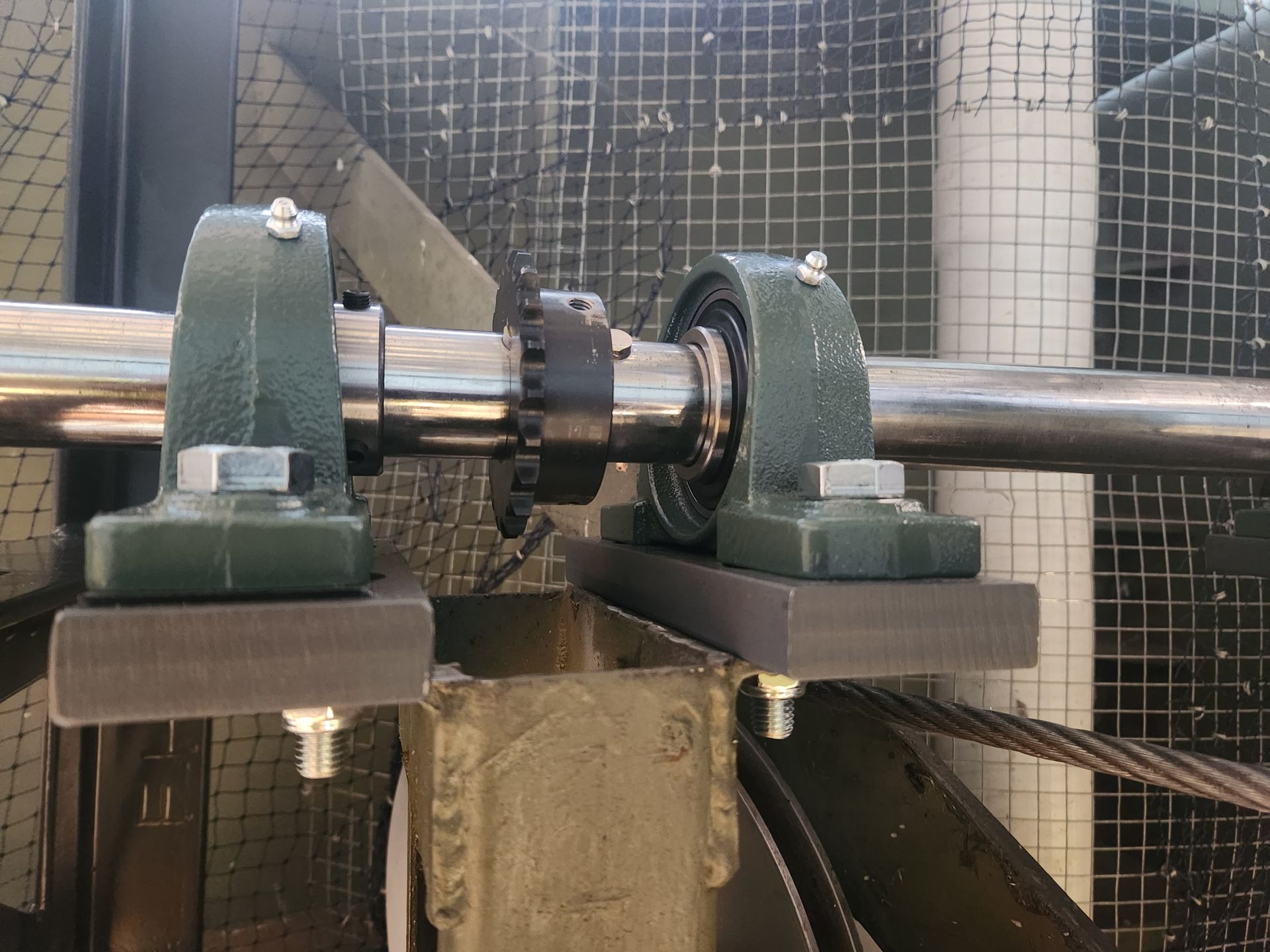 A close up of a machine with a cage in the background