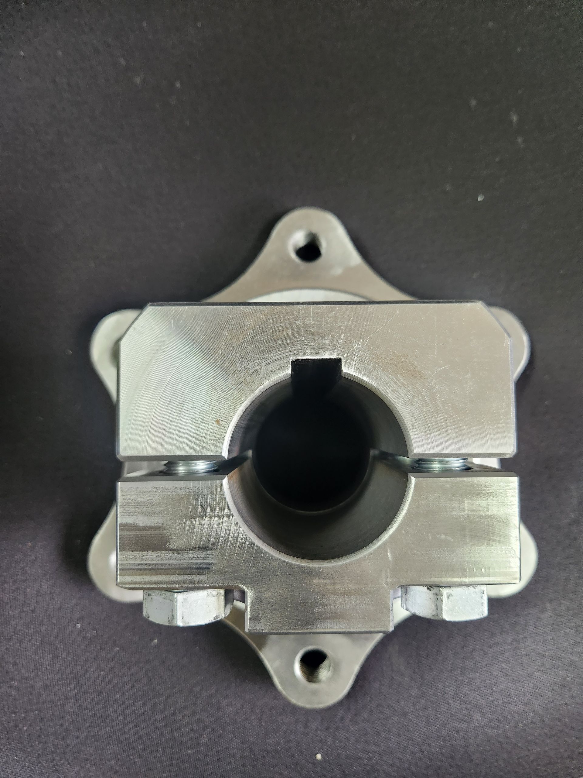 A metal object with a hole in the middle is sitting on a table.