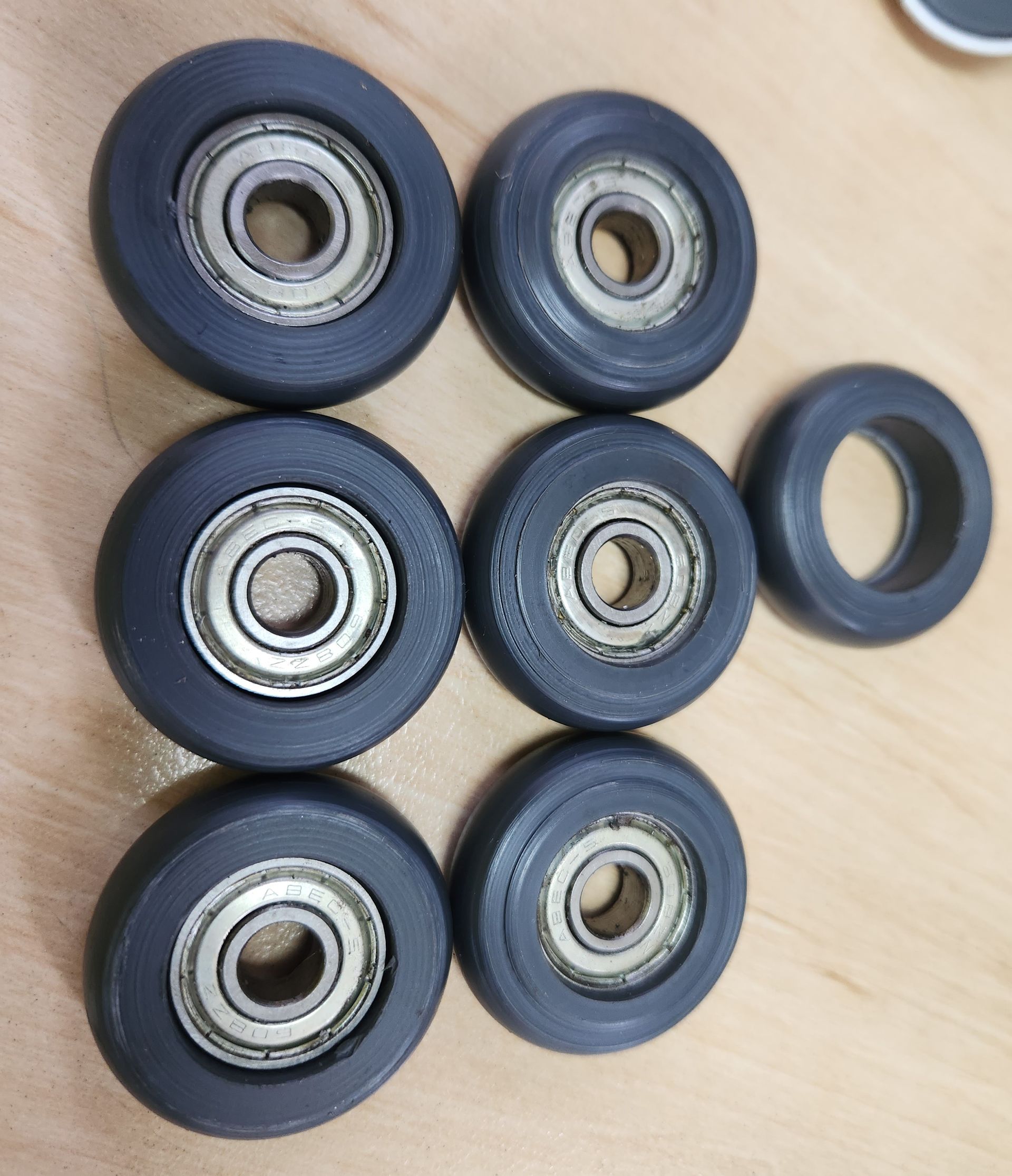 A bunch of black wheels with bearings on them