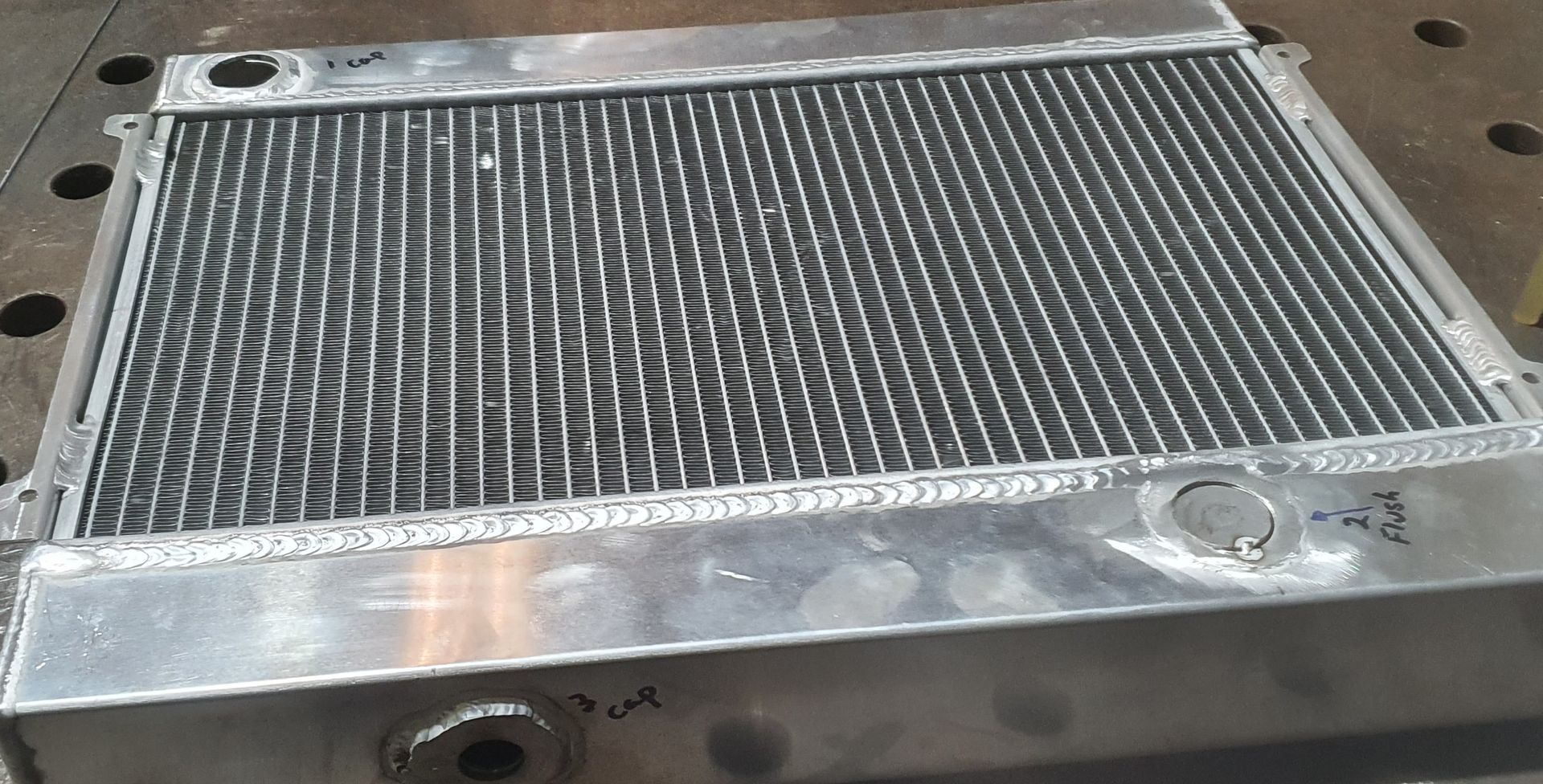 A metal radiator is sitting on top of a metal table.