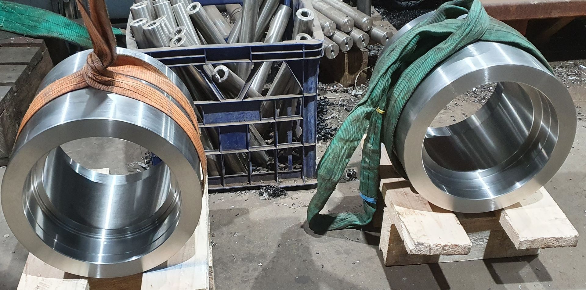 Two large metal rings are sitting on a wooden pallet