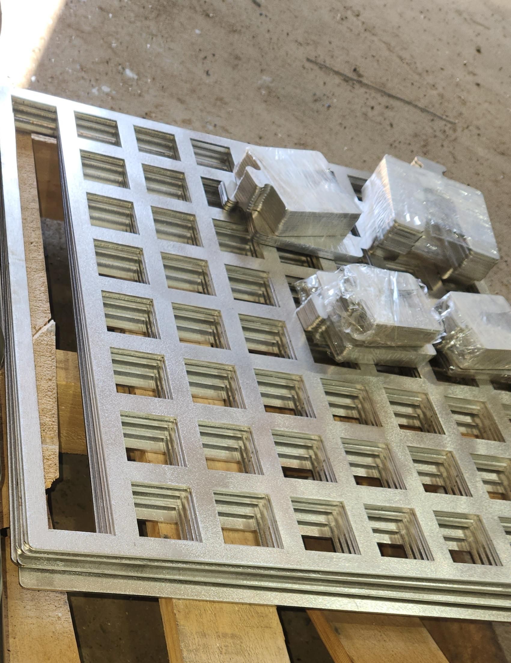A stack of metal pieces sitting on top of a wooden pallet