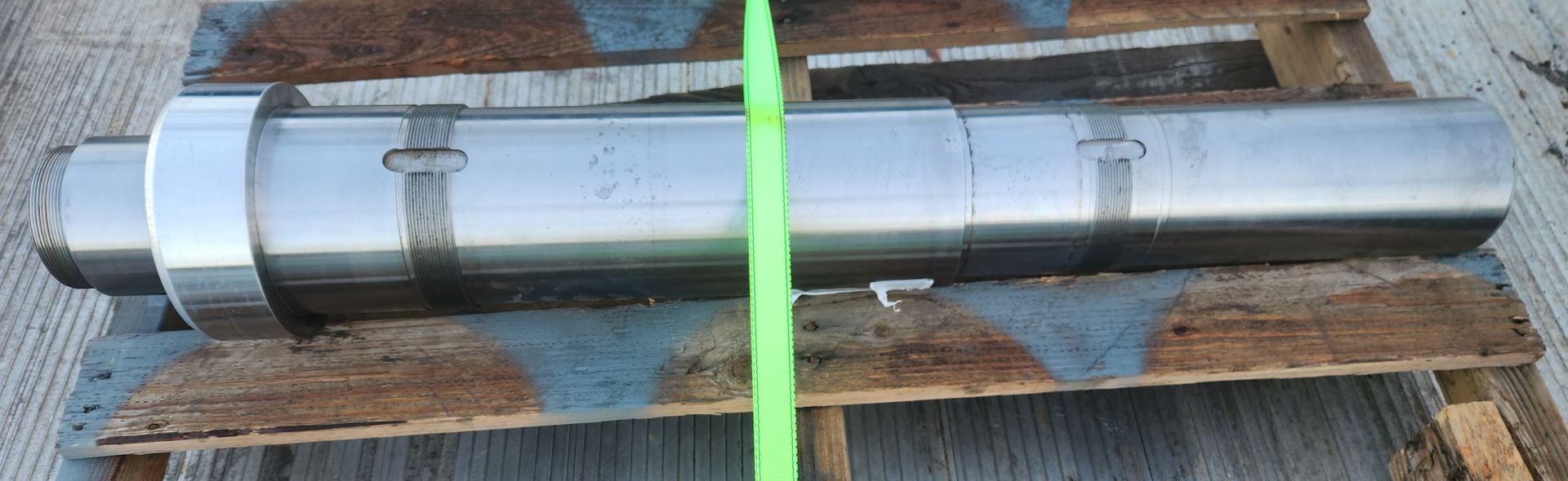 A large metal object is sitting on top of a wooden pallet.