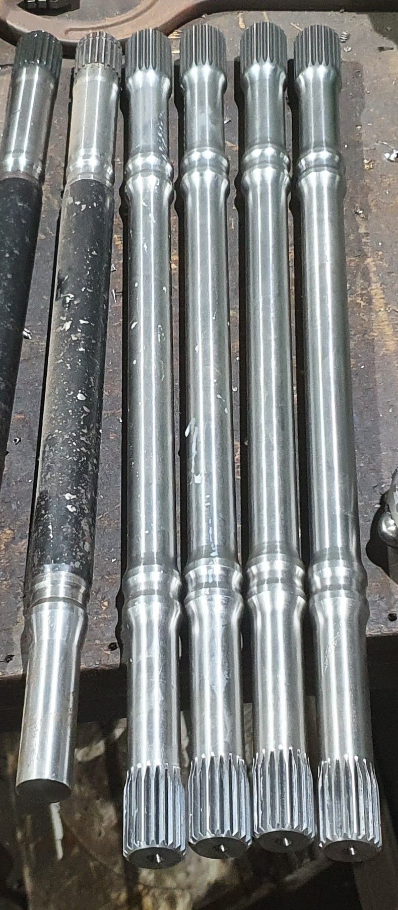 A bunch of metal rods are sitting on top of each other on a table.