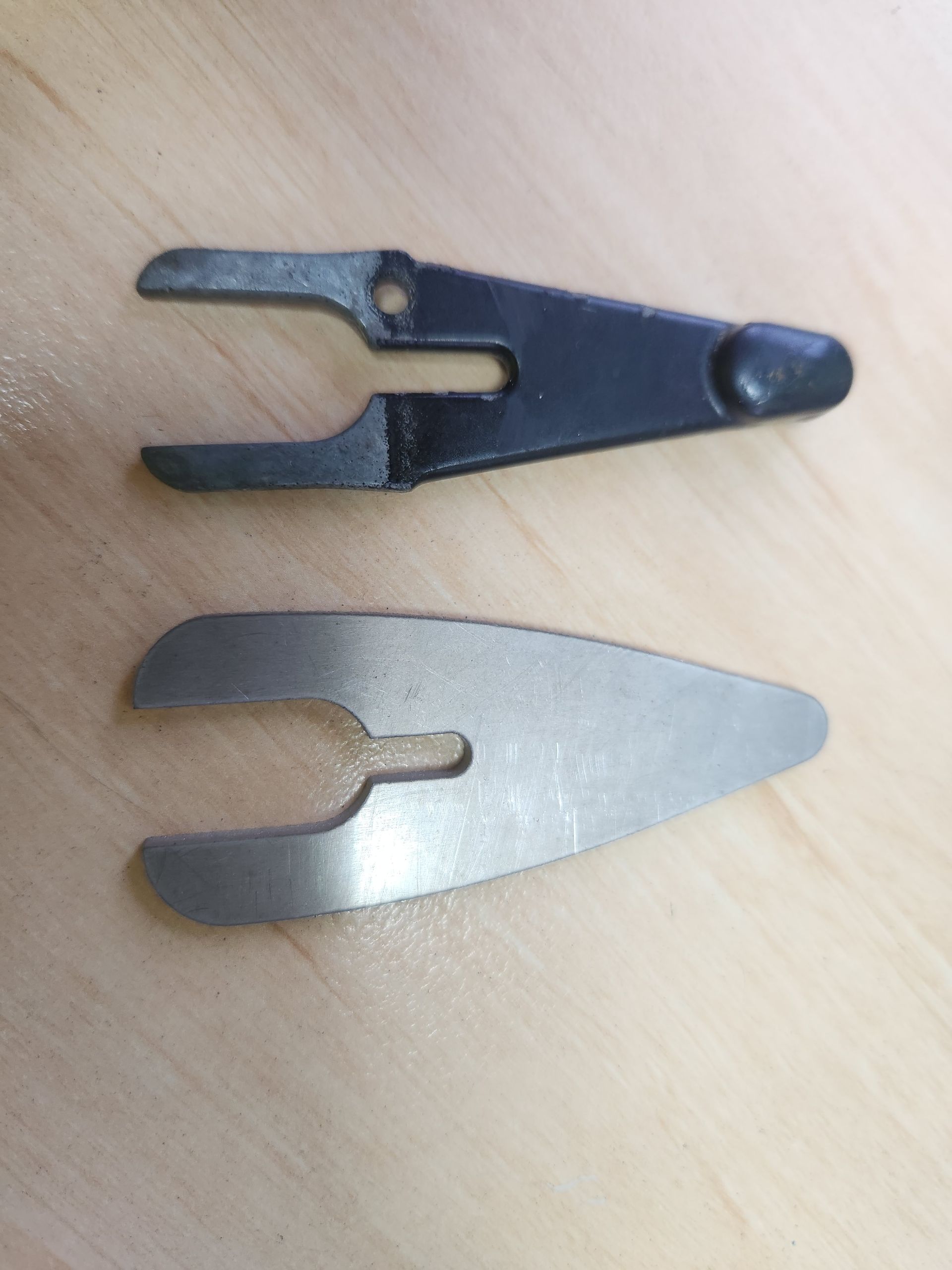 A pair of scissors sitting on top of a wooden table.