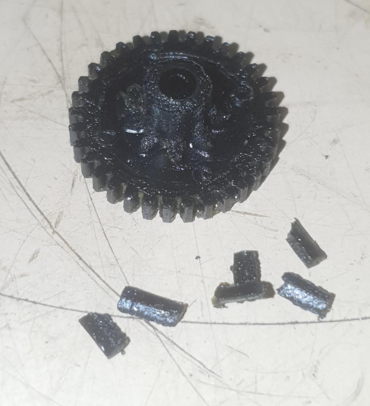A black gear is sitting on a white surface