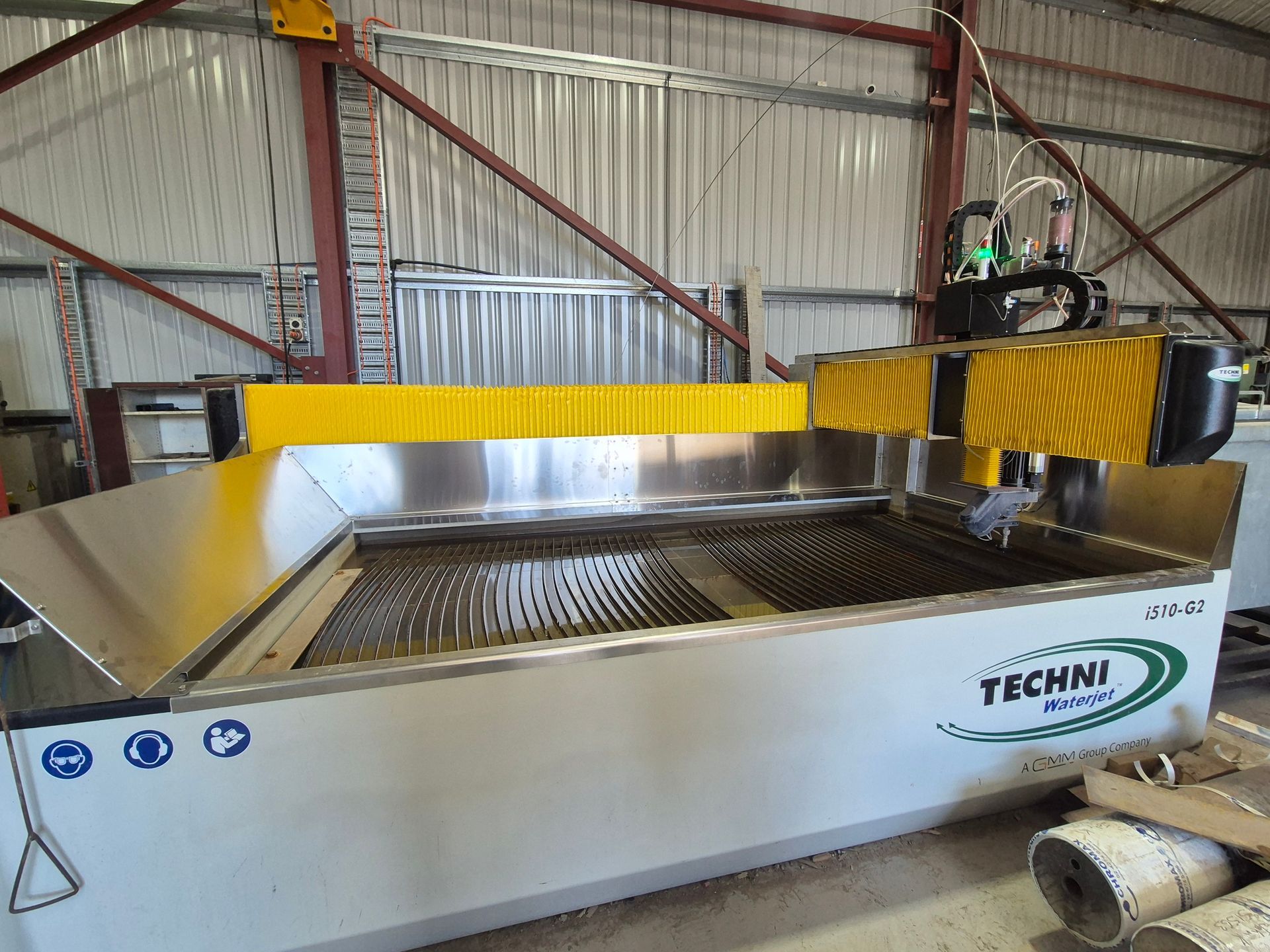 A water jet machine is sitting in a warehouse.