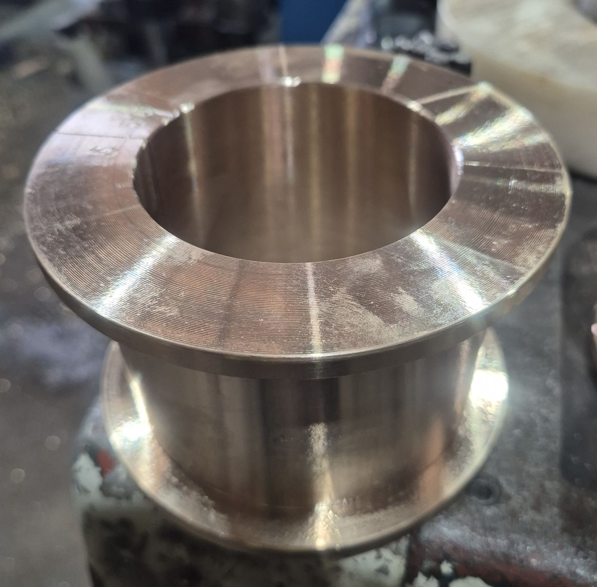 A metal cylinder with a hole in the middle sits on a table