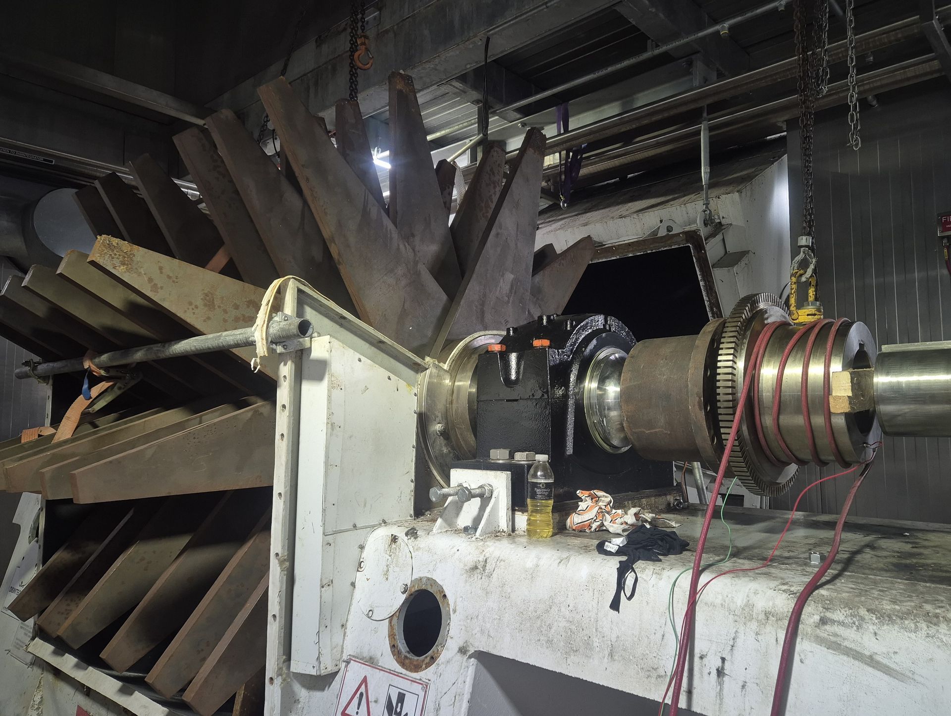 A large machine is being worked on in a dark room.