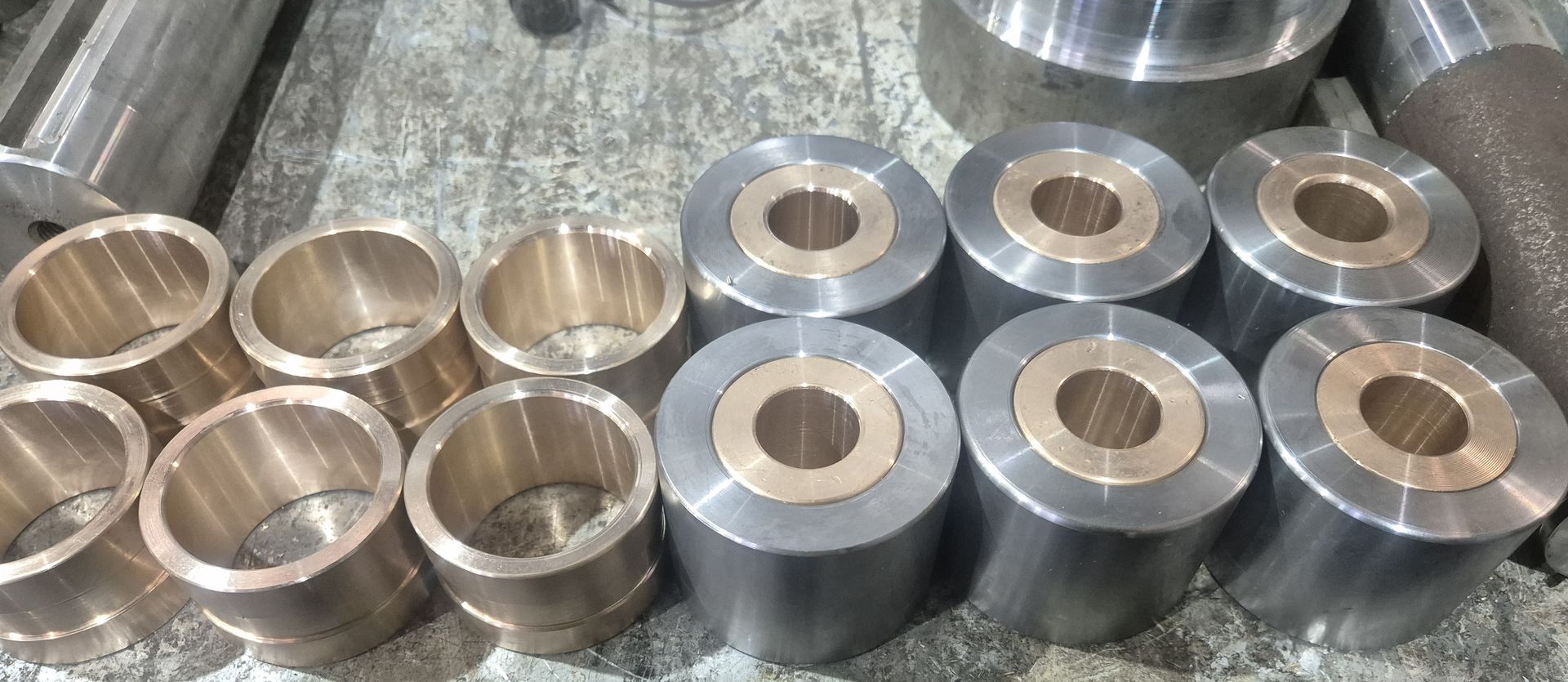 A bunch of metal cylinders with holes in them are sitting on a table.