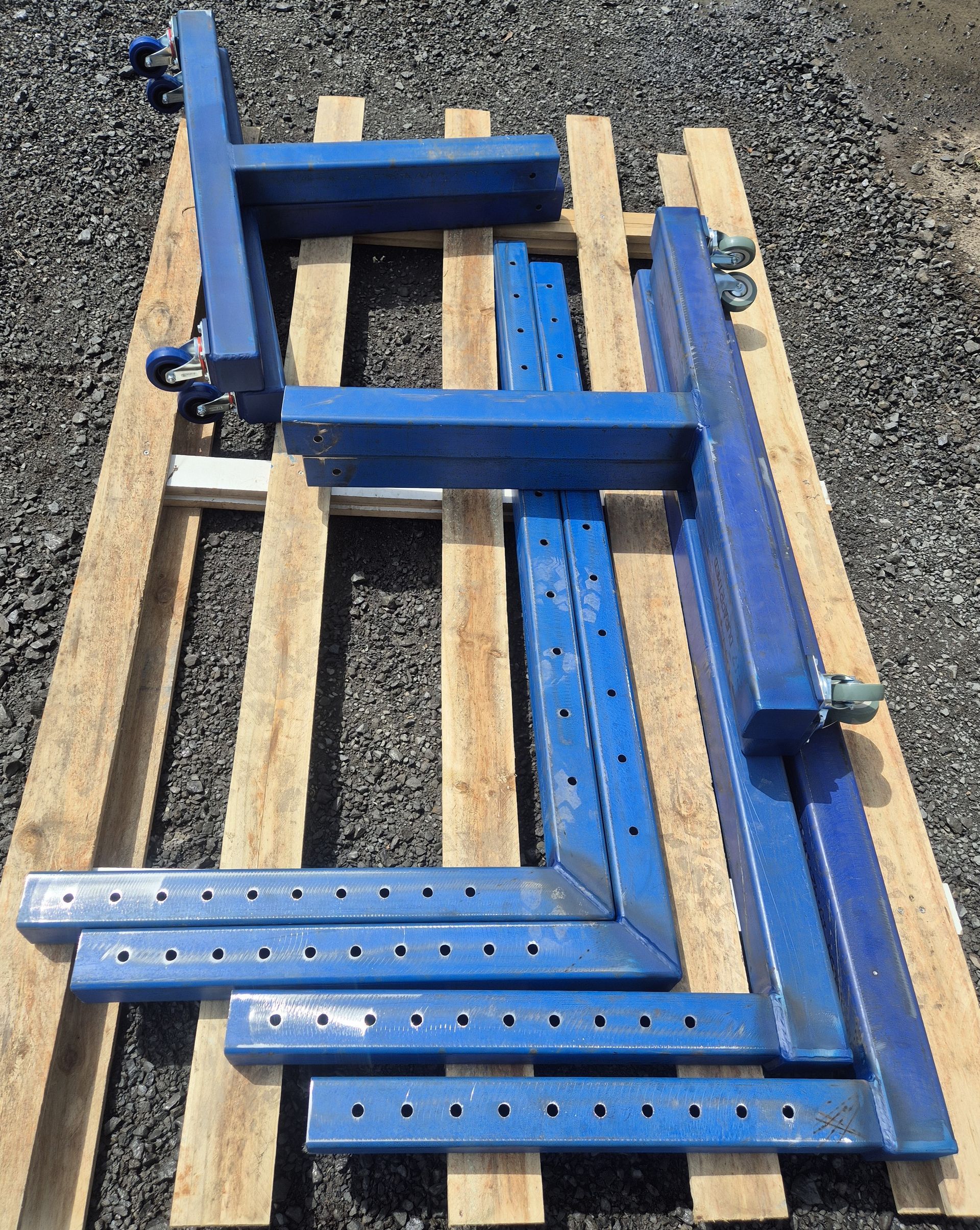 A blue metal object is sitting on a wooden pallet