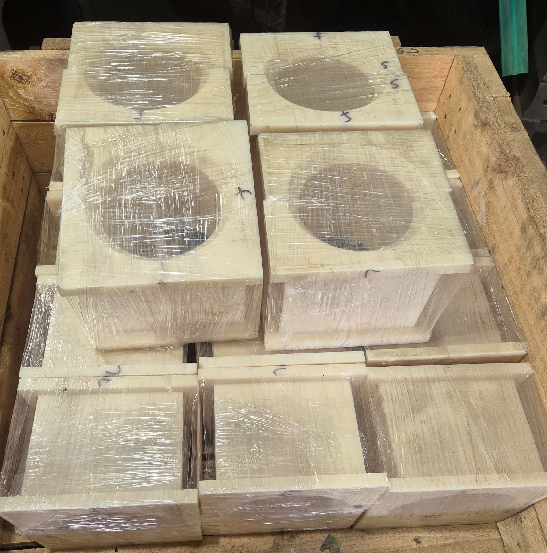 A wooden box filled with squares wrapped in plastic