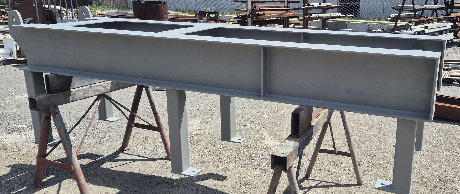 A large piece of metal is sitting on top of a wooden trestle.