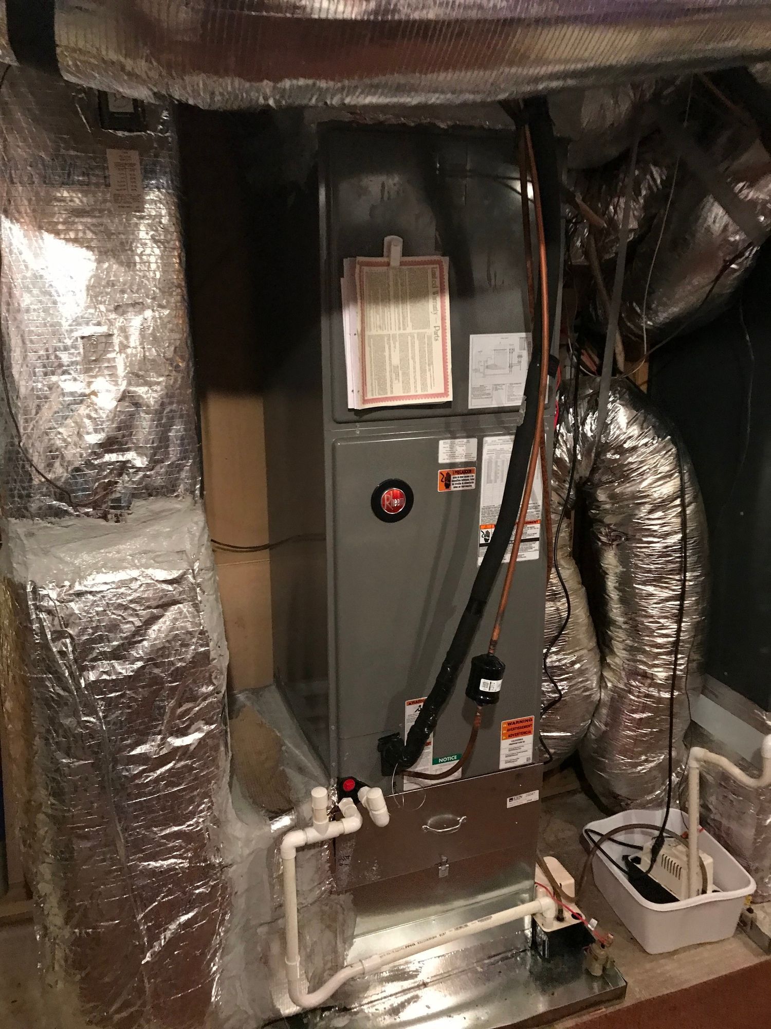 A picture of an air conditioner in a basement.