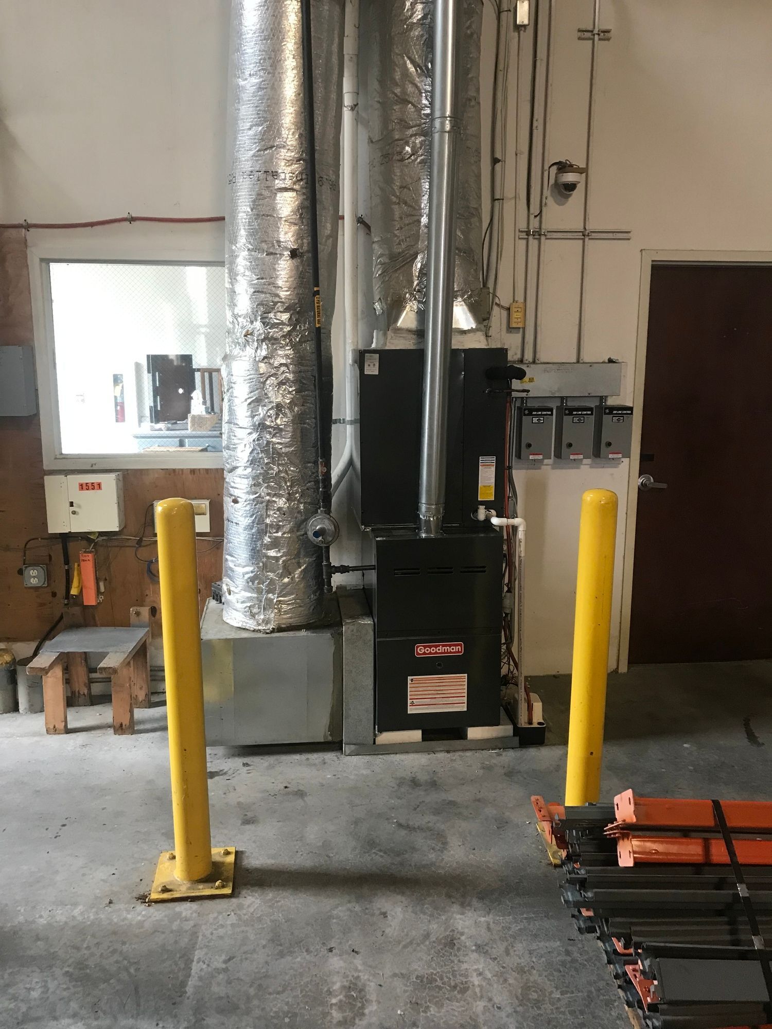 A room with a stove in the middle of it