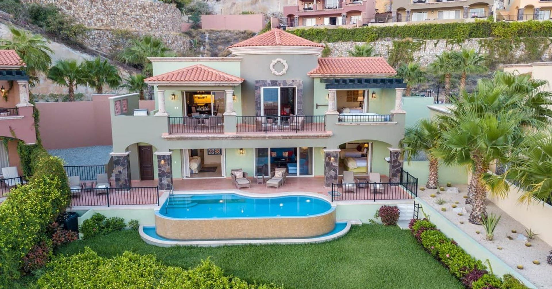 An aerial view of a large house with a swimming pool. Vacation Travel Exclusives