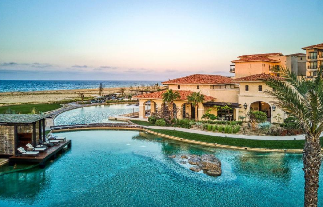An aerial view of Pacific Dunes next to Pool and Pacific Ocean. Vacation Travel Exclusives