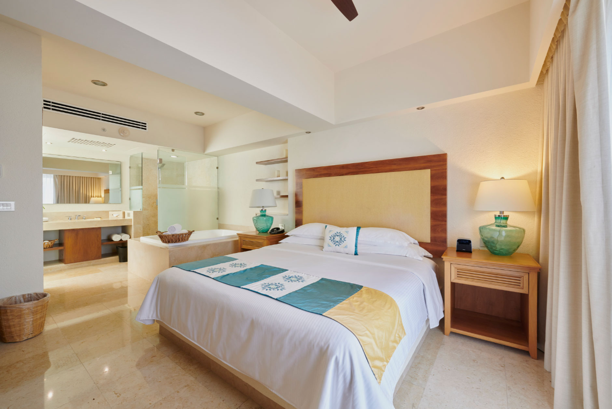 There is a large bed in the middle of the room in Puerto Vallarta. Vacation Travel Exclusives