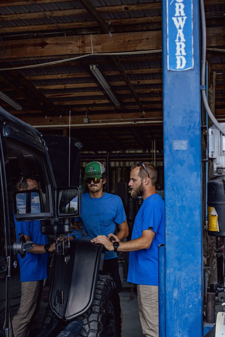 Mechanic Repairing Car Dent — Eustis, FL — Bay Street Paint and Body