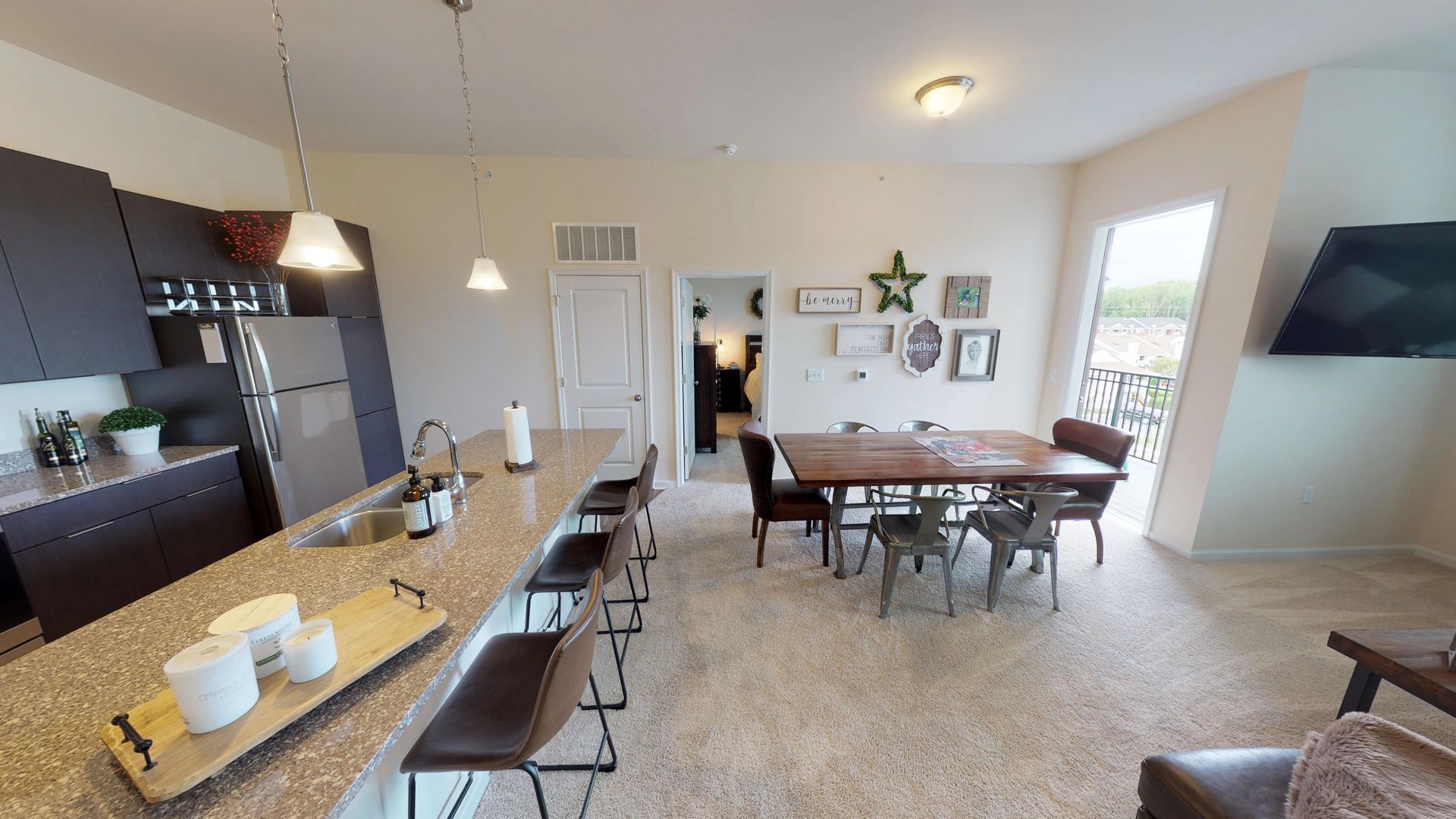 A kitchen and dining room in a house with a table and chairs