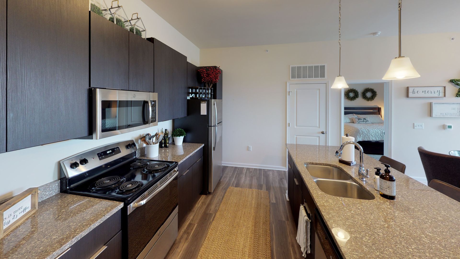 A kitchen with stainless steel appliances and granite counter tops.