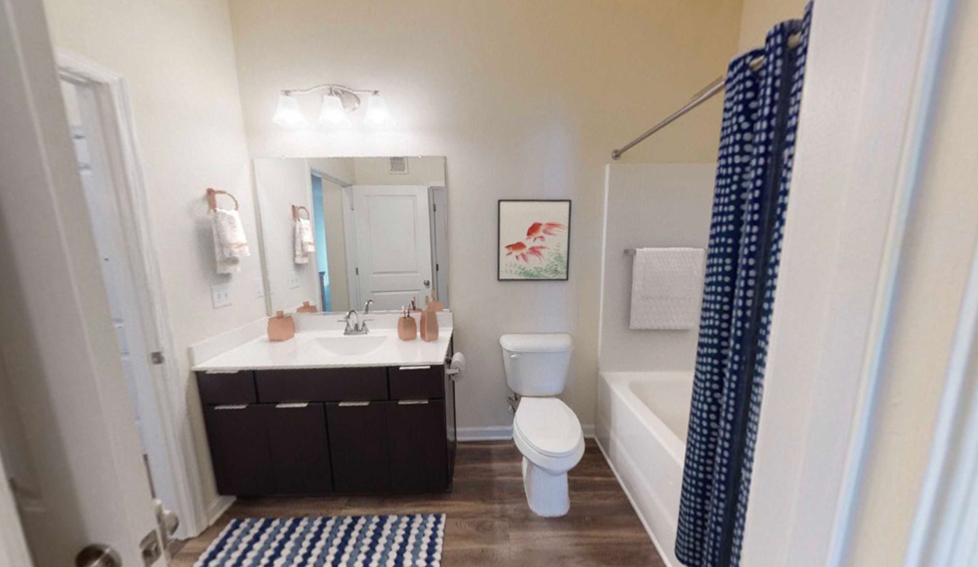 A bathroom with a toilet , sink , and bathtub.