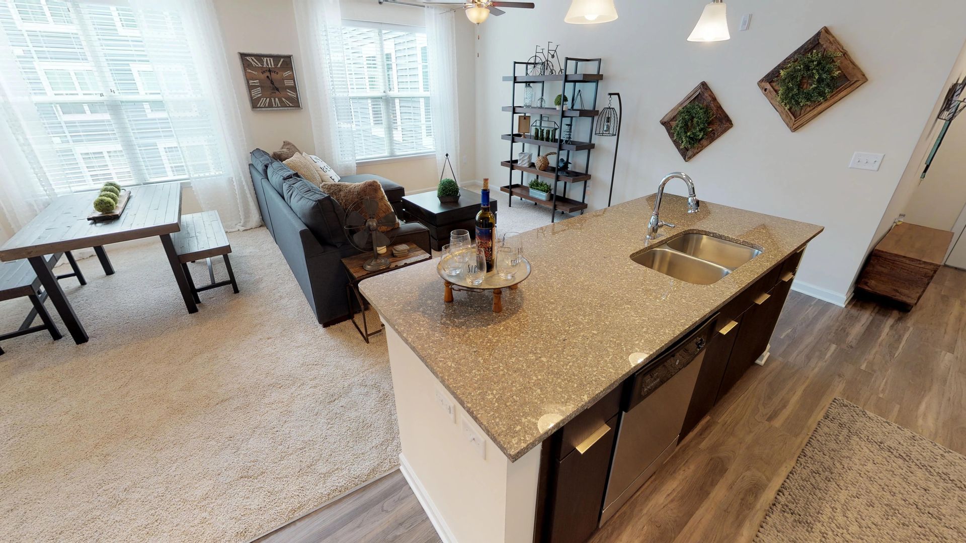A kitchen with granite counter tops and stainless steel appliances.