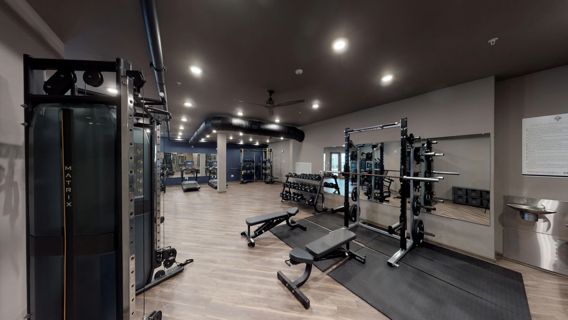 A large gym with a lot of exercise equipment